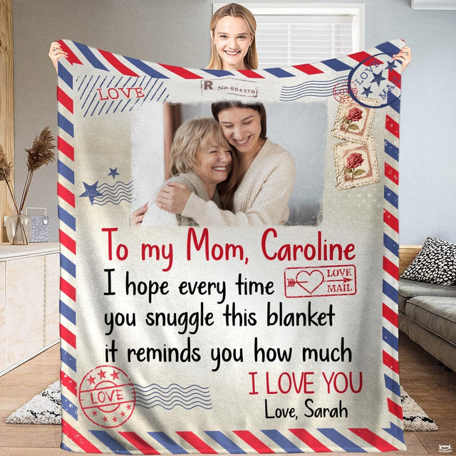 Airmail letter blanket held up displaying red and blue diagonal borders and postage stamp graphics