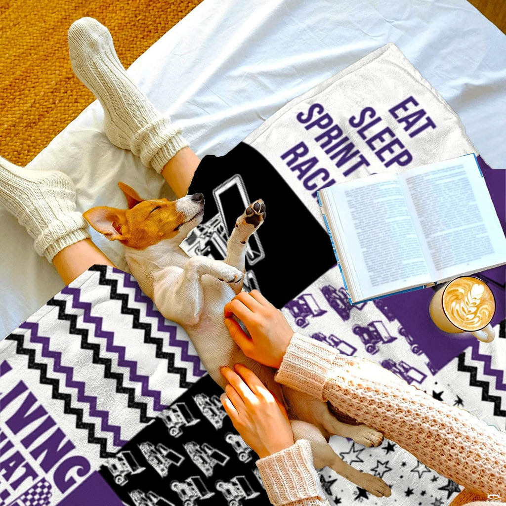 Stylized bedroom display showing purple and black race thematic accent bedding set with celestial collage pattern.