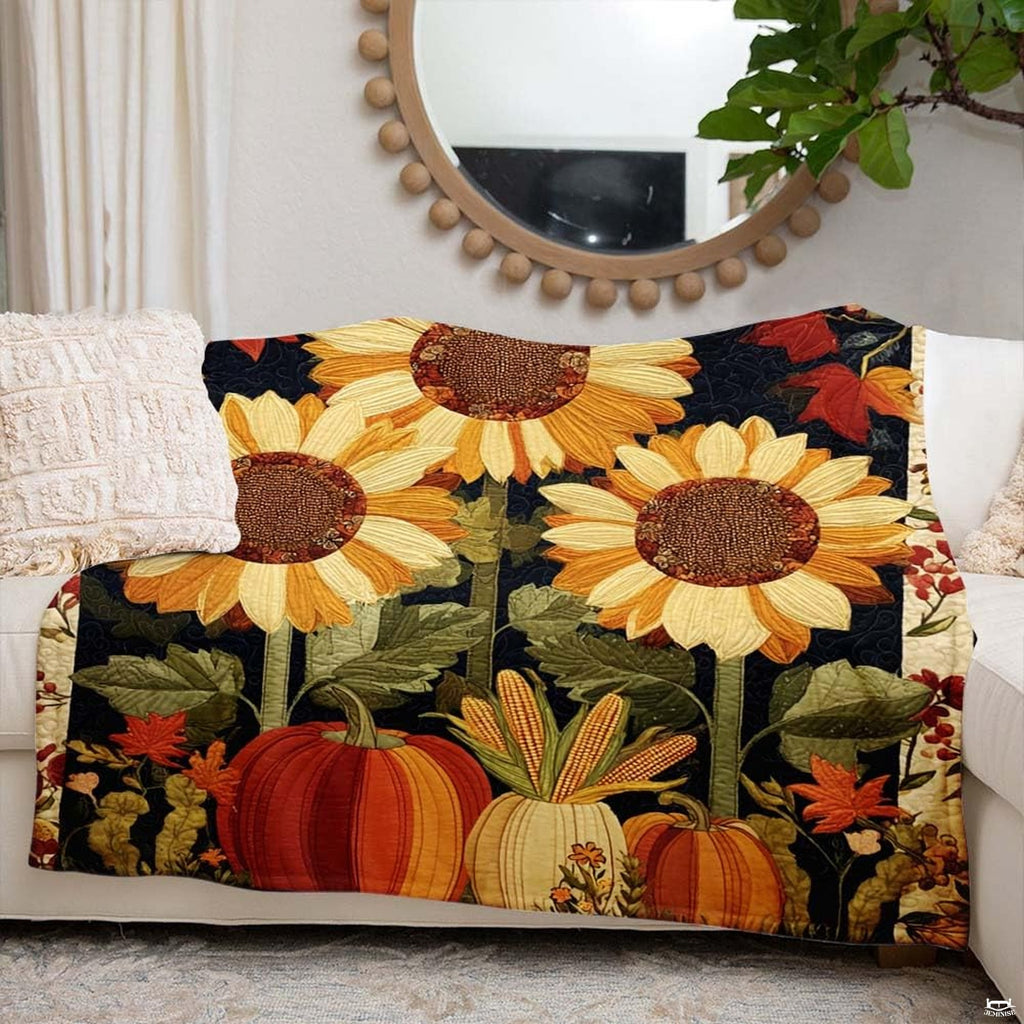 Autumn sunflower blanket styled across a rustic armchair beside festive seasonal home decorations