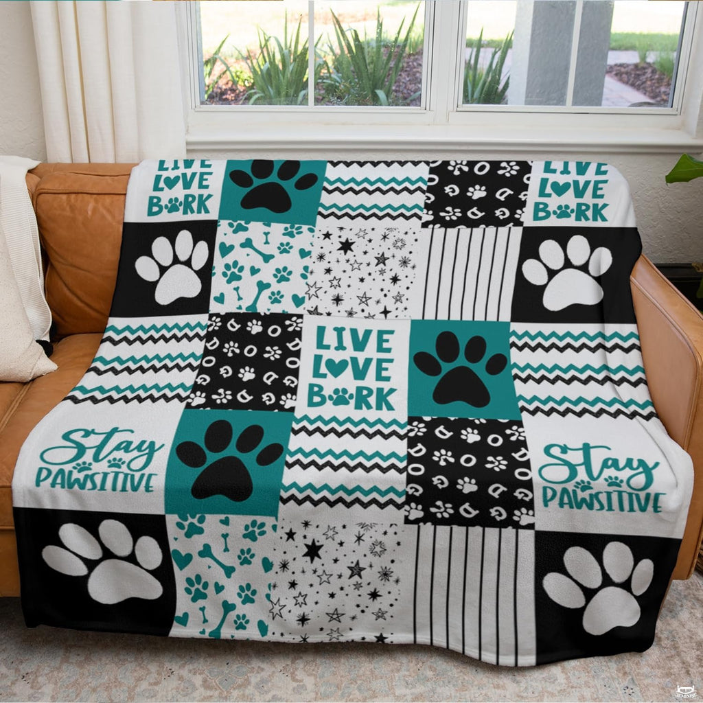 Teal dog paw print throw blanket view 3 highlighting patchwork pattern squares, bones, and stripes
