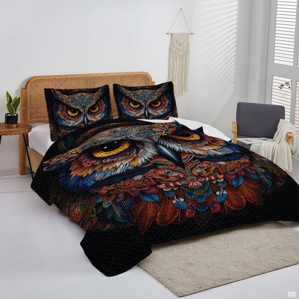Overhead perspective of owl bedding arranged neatly across a mattress with midnight room decor