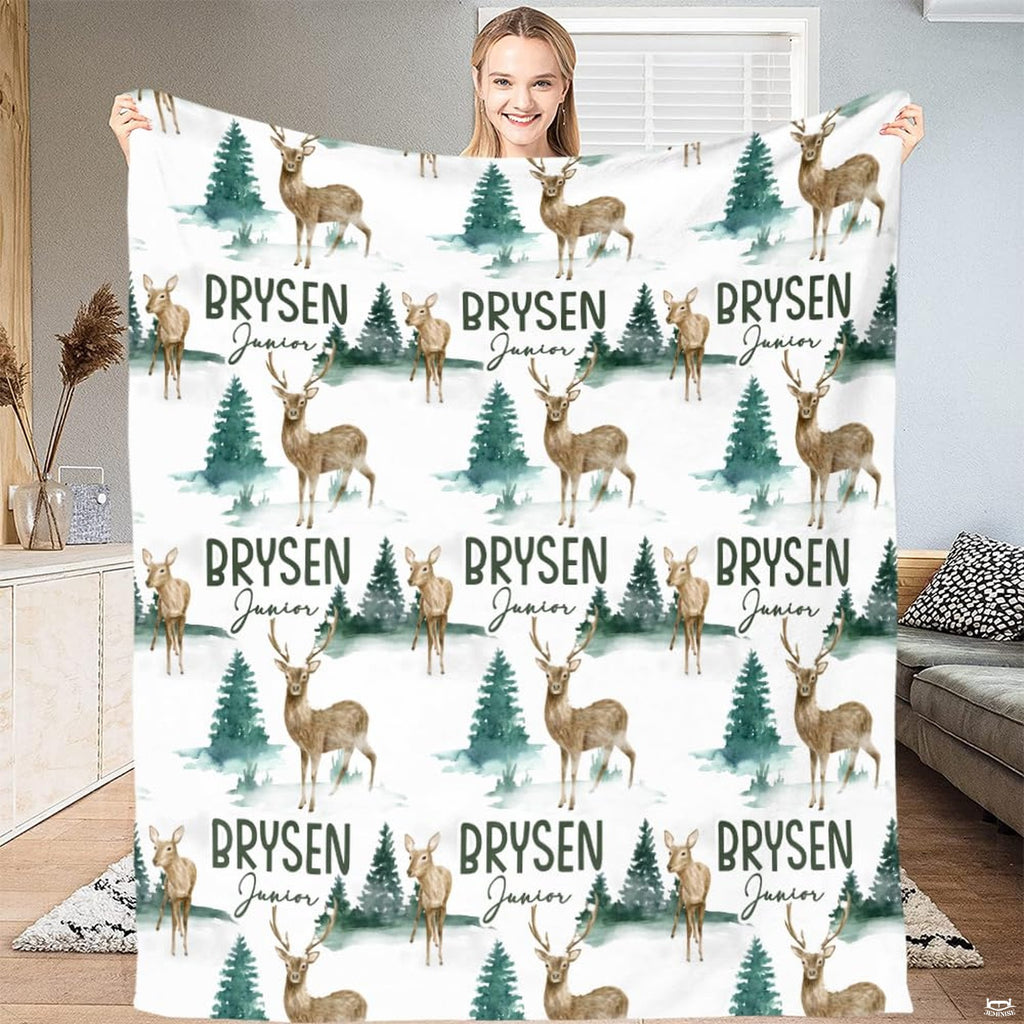 Close-up of hand-painted horned stag and fawn watercolor artwork across wilderness bedding.