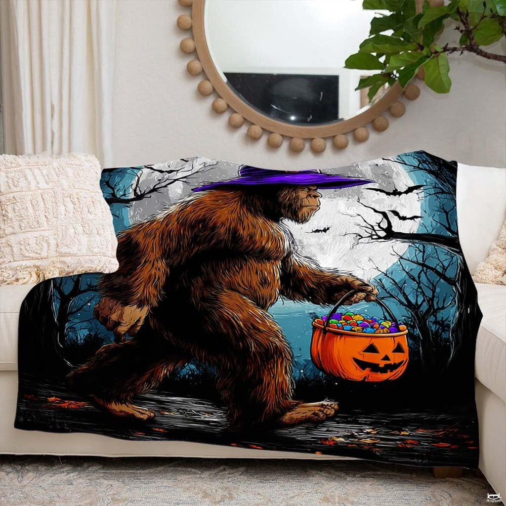 Bigfoot in a purple witch hat carrying a pumpkin candy bucket on Halloween night, view 6.