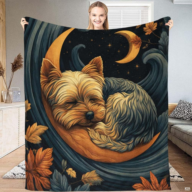 Sleeping Yorkshire Terrier curled in a golden crescent moon amid starry night sky and autumn leaves throw blanket