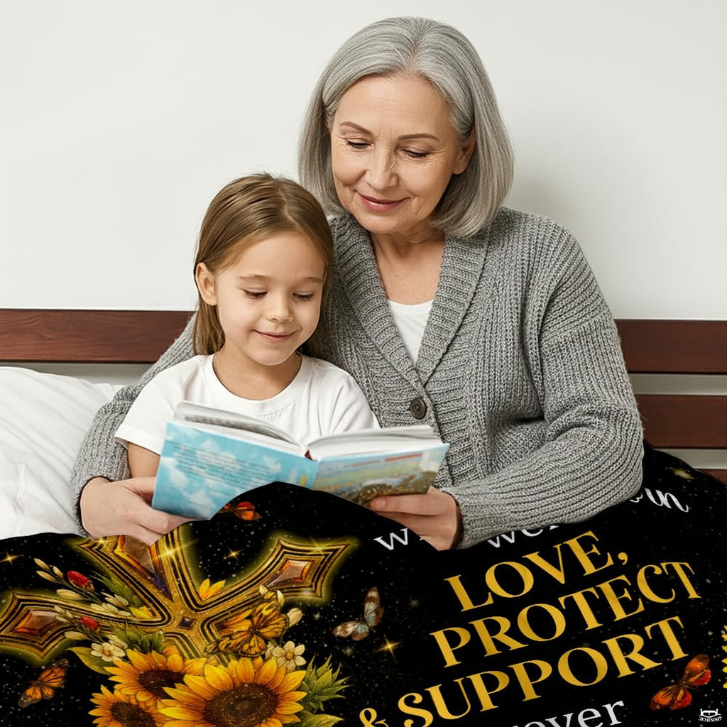Close-up of radiant golden cross decorated with blooming sunflowers and fluttering butterflies on a blanket