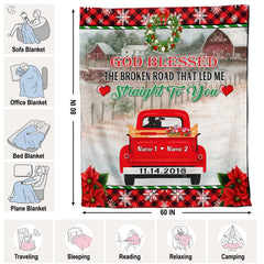 Close-up of decorative holiday wreath and vibrant poinsettia accents on Christmas red truck artwork.