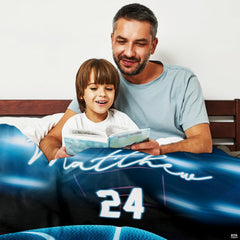 Close-up perspective of glowing blue basketball graphics on throw blanket