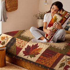 Full room display of patchwork maple leaf bedding set styled in an inviting country farmhouse bedroom