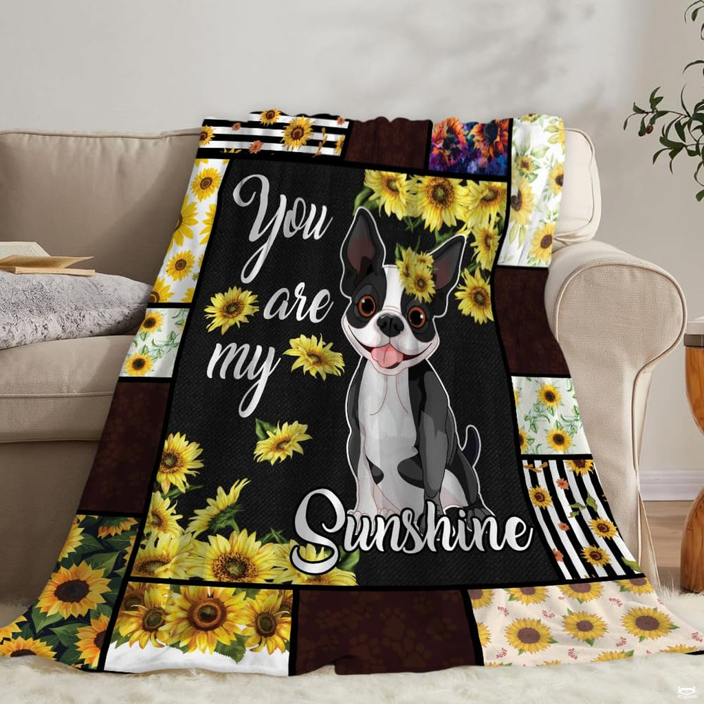 Overhead perspective of artistic puppy portrait surrounded by vibrant yellow botanical blooms.
