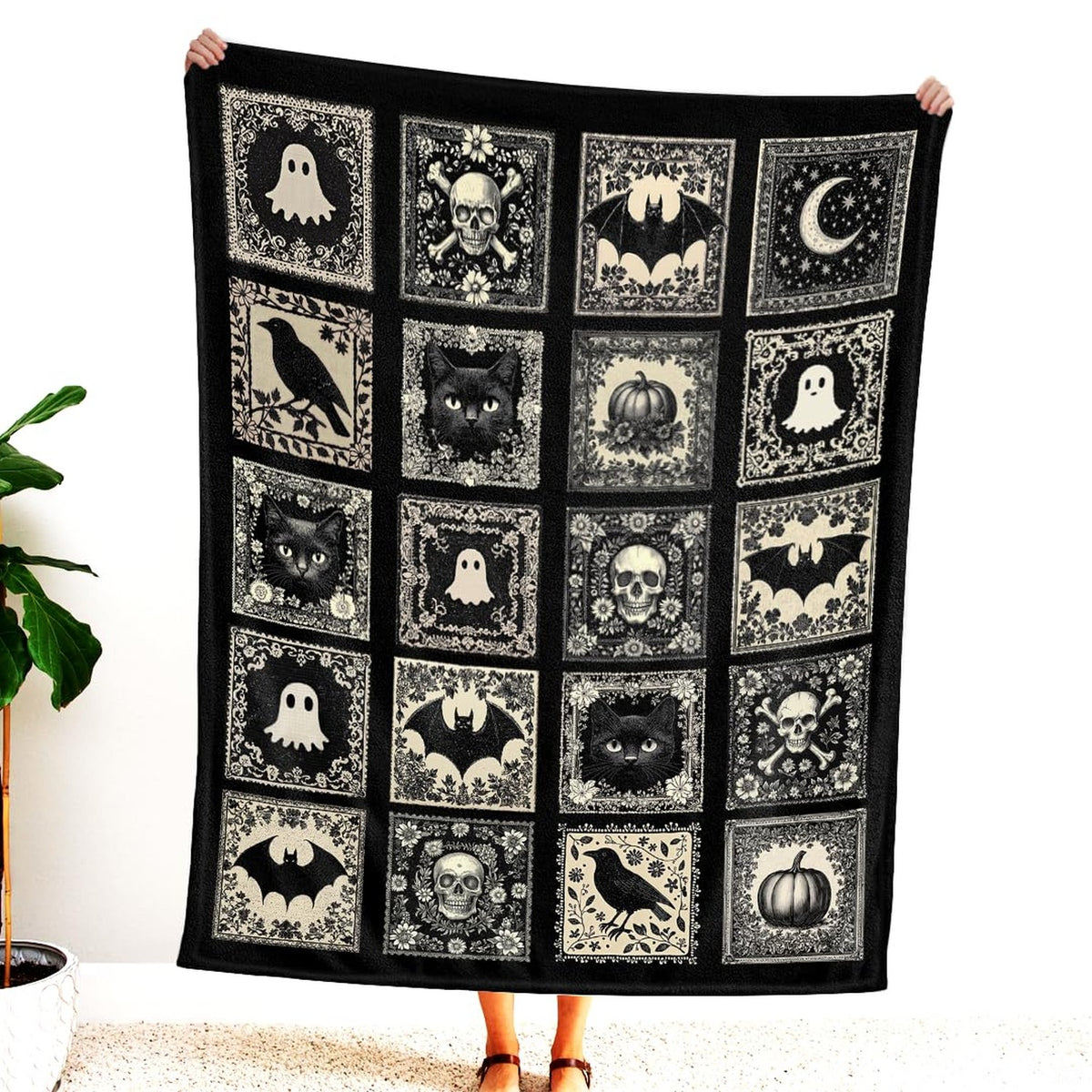 Folded view of the cameo tile blanket showing perimeter border hem and monochrome contrast.