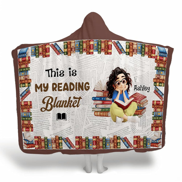 Bookshelf border literary throw blanket showing illustrated book lover, stacked novels, and vintage newsprint