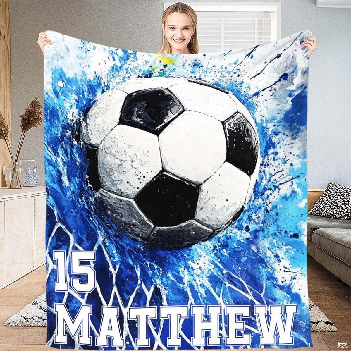 Soccer ball bursting into goal net with energetic royal blue splatter artwork.