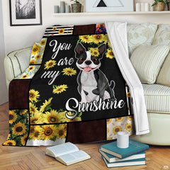 Illustrated bulldog pup artwork with blooming sunflowers and patchwork paw print borders.