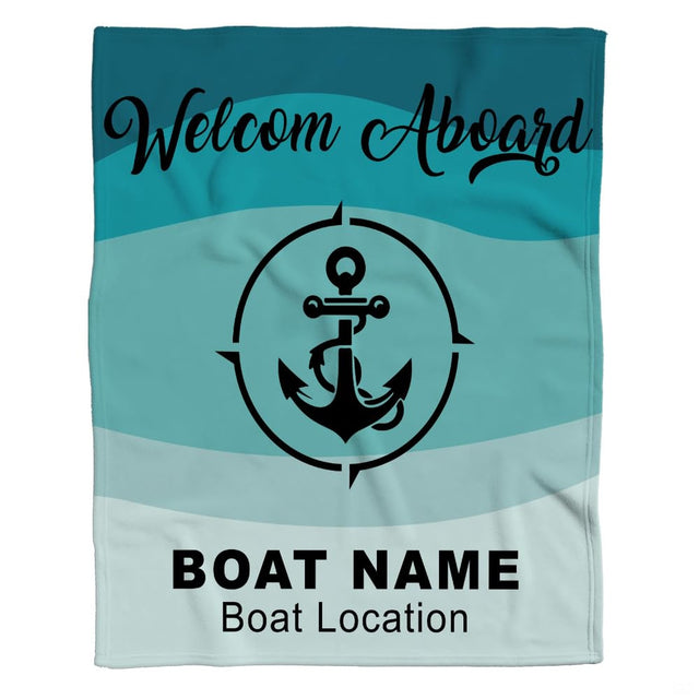Flat layout of nautical blanket featuring central anchor compass design over aqua wave bands