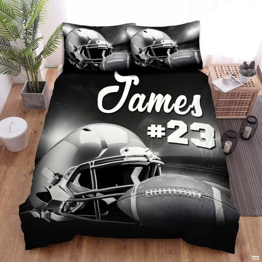 Monochrome football bedding displaying metallic helmet and textured ball on stadium field under arena floodlights