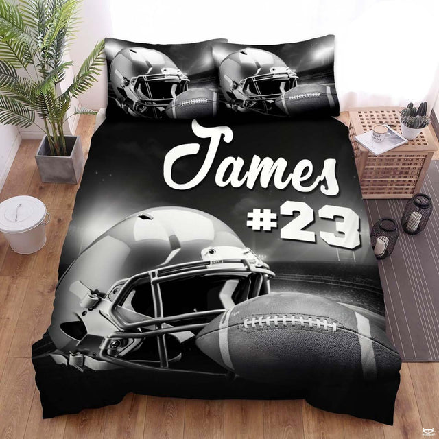 Monochrome football bedding displaying metallic helmet and textured ball on stadium field under arena floodlights