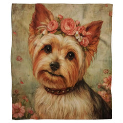 Close-up of the painted Yorkie face highlighting pink rose blossoms, gentle dark eyes, and studded collar on a blanket