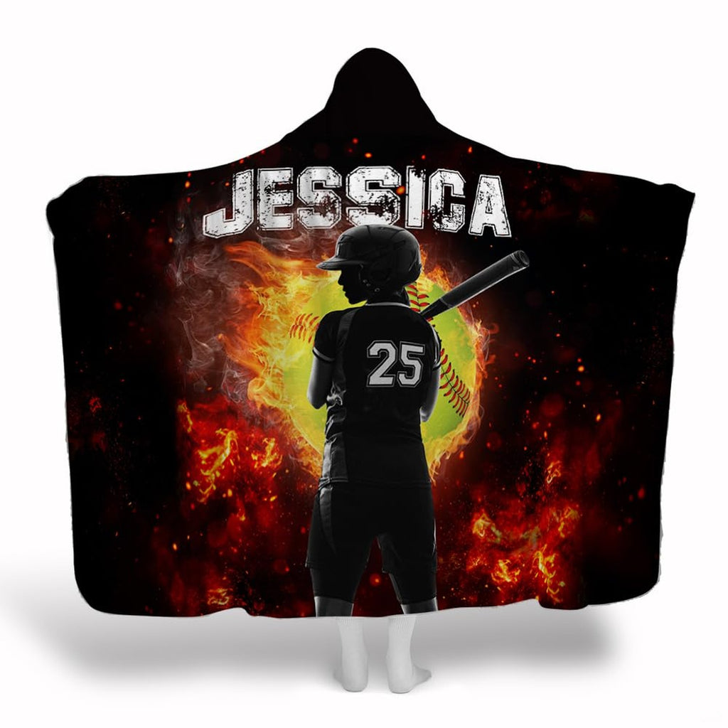 Front display of female softball batter standing before a fiery flaming softball graphic on black background.