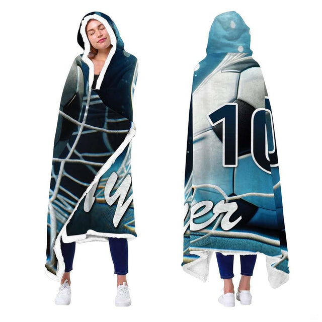 Person showcasing soccer blanket with night arena floodlights and goal net scoring artwork