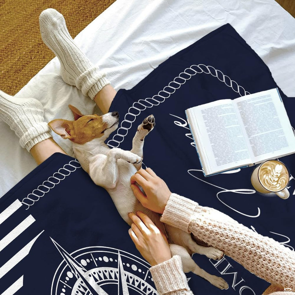 Navy coastal bedroom setup showcasing nautical compass bedding and ocean-inspired decor.