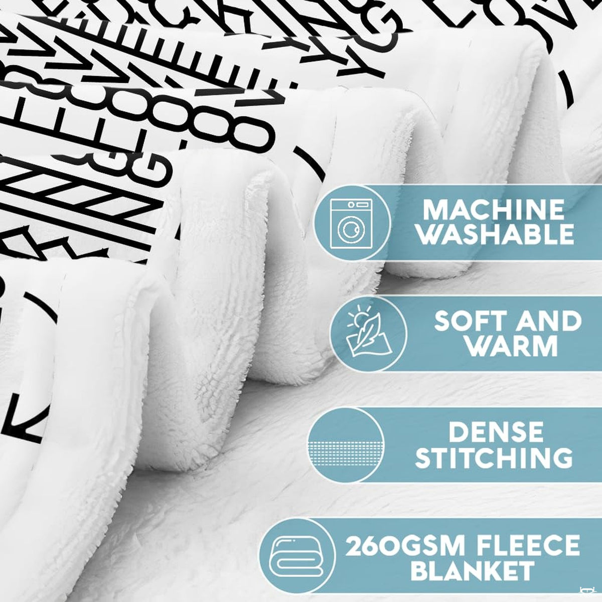Optical illusion hidden message throw blanket draped over gray living room sofa