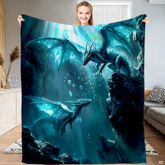 Full view of throw blanket displaying two teal winged dragons in an underwater cavern with bubbles and sunbeams.