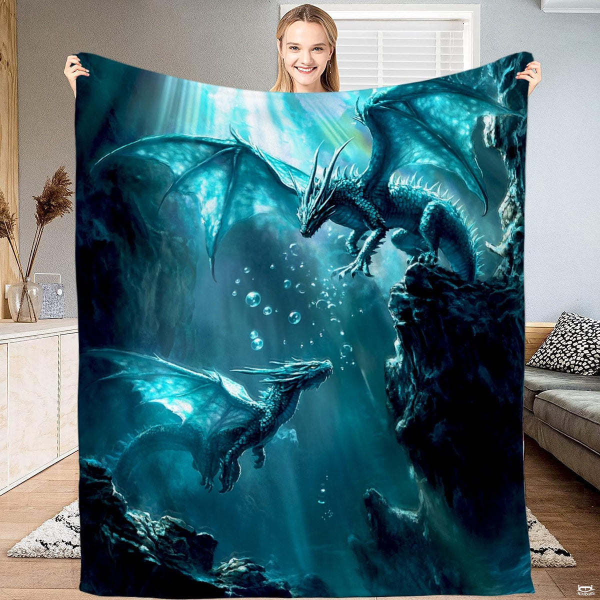 Full view of throw blanket displaying two teal winged dragons in an underwater cavern with bubbles and sunbeams.