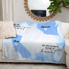Close up of long distance friendship map throw blanket displaying dotted travel pathway and script