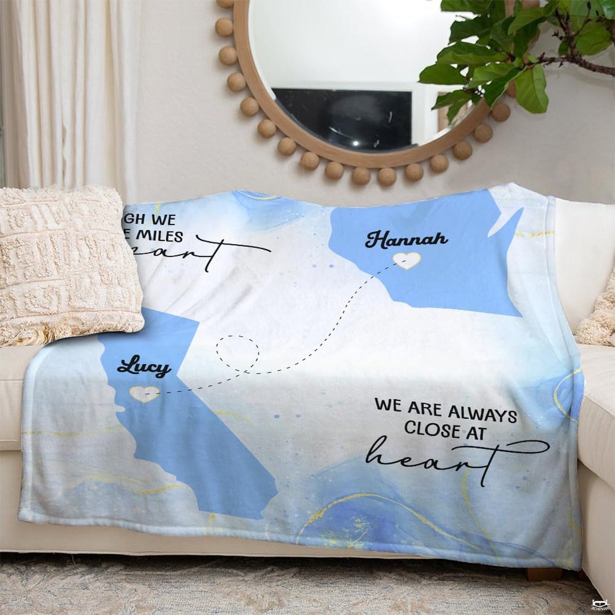 Close up of long distance friendship map throw blanket displaying dotted travel pathway and script