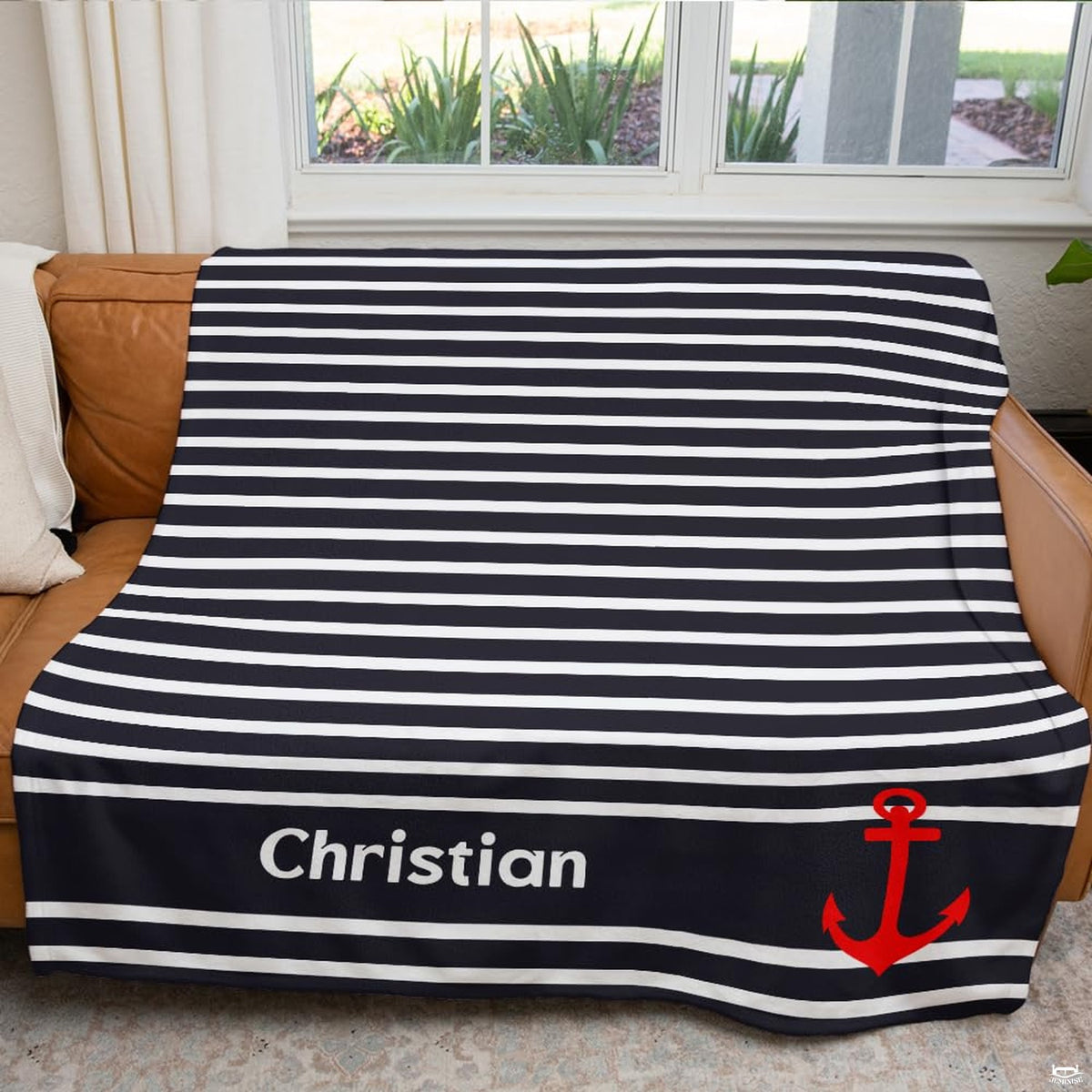 Coastal bedroom visual styling featuring navy sailor bands and bold red maritime anchor graphics.