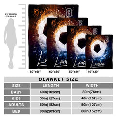 Two models holding open the dynamic soccer ball fire and ice sports blanket outdoors.