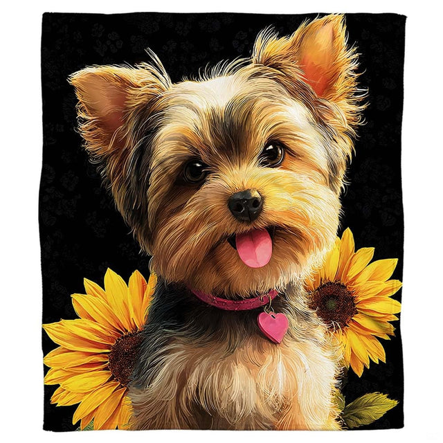 Close-up of the smiling Yorkie face with open mouth, pink tongue, and pink heart collar tag on a blanket