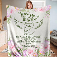 Full view of angel wings infant footprint memorial blanket held up indoors.