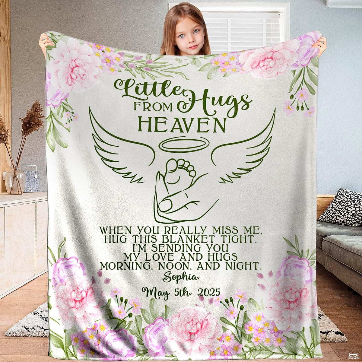 Full view of angel wings infant footprint memorial blanket held up indoors.