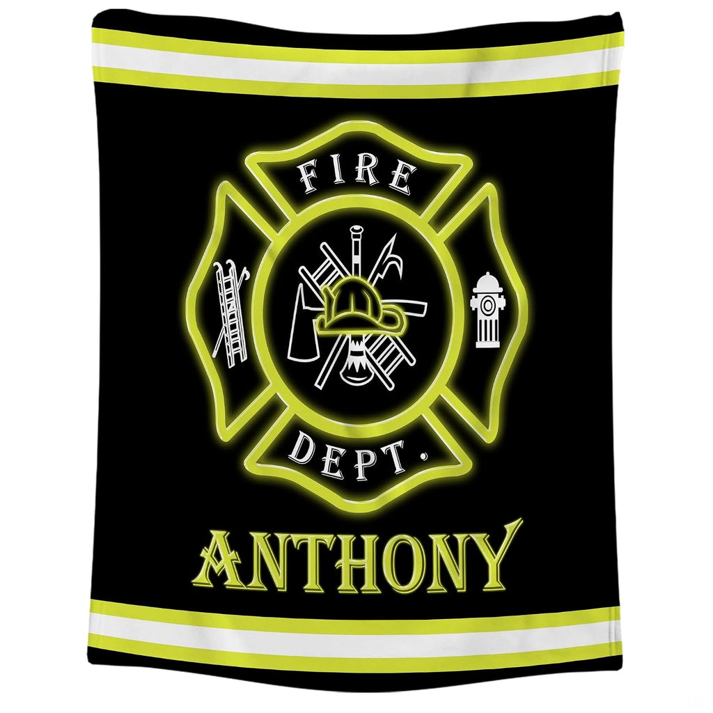 Close-up of the red Maltese cross badge displaying firefighter helmet, ladder, axe, and hydrant icons on a blanket