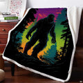 Neon Bigfoot blanket draped over an armchair beside a wooden nightstand in an indoor room setting.