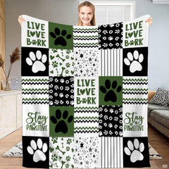 Dog paw bedding set featuring an olive green, black, and white patchwork grid motif with stars and chevron artwork.