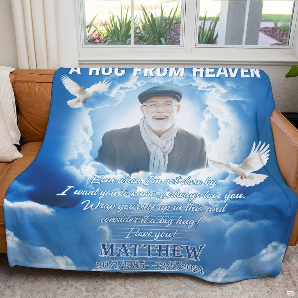 Heavenly memorial throw blanket draped across brown leather couch in bright living room