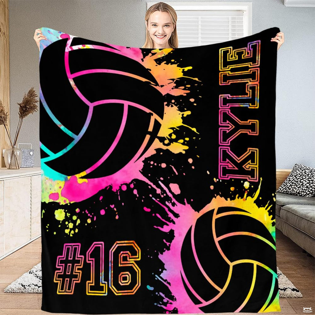 Volleyball bedding set displaying neon watercolor paint splatters and stylized sports graphics on a dark background.