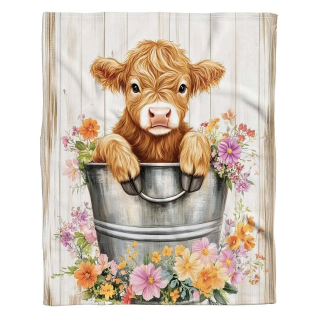 Cute baby Highland calf in vintage metal pail surrounded by colorful wildflowers, view 2.