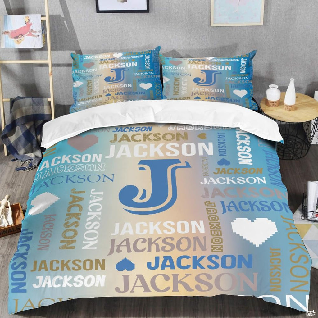 Teal monogram bedding displaying central initial letter surrounded by aqua and sand word-cloud typography
