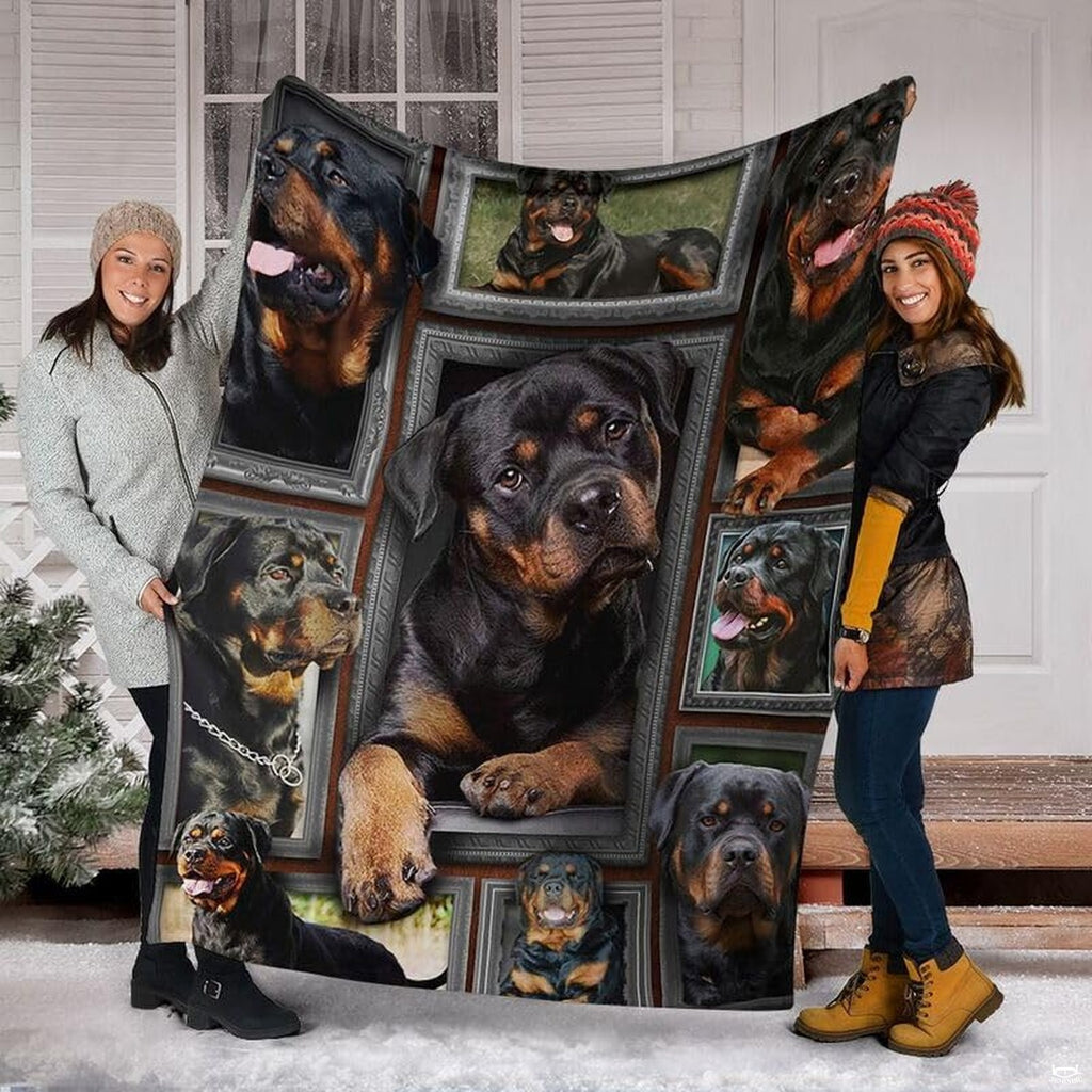 Two models displaying the Rottweiler blanket outside a snowy winter home entrance.
