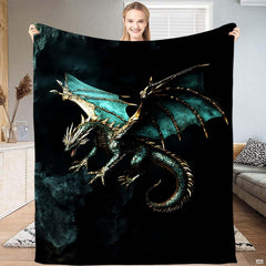 Detailed close-up of teal dragon throw blanket highlighting emerald scales and burnished gold wing accents.