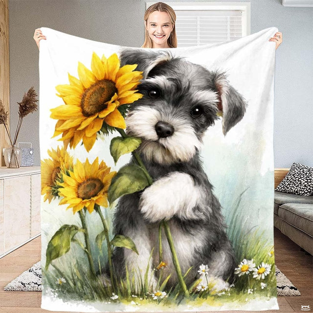 Miniature Schnauzer puppy holding bright yellow sunflowers in a watercolor meadow throw blanket