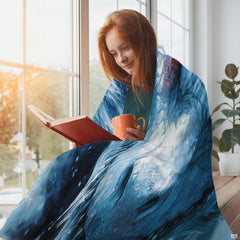 Lifestyle display of a person resting with the ice dragon fantasy throw blanket.