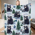 Black bear cub winter pine forest throw blanket with snowy trees and sapphire crystals on pale blue