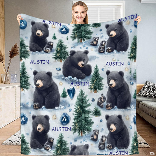 Black bear cub winter pine forest throw blanket with snowy trees and sapphire crystals on pale blue