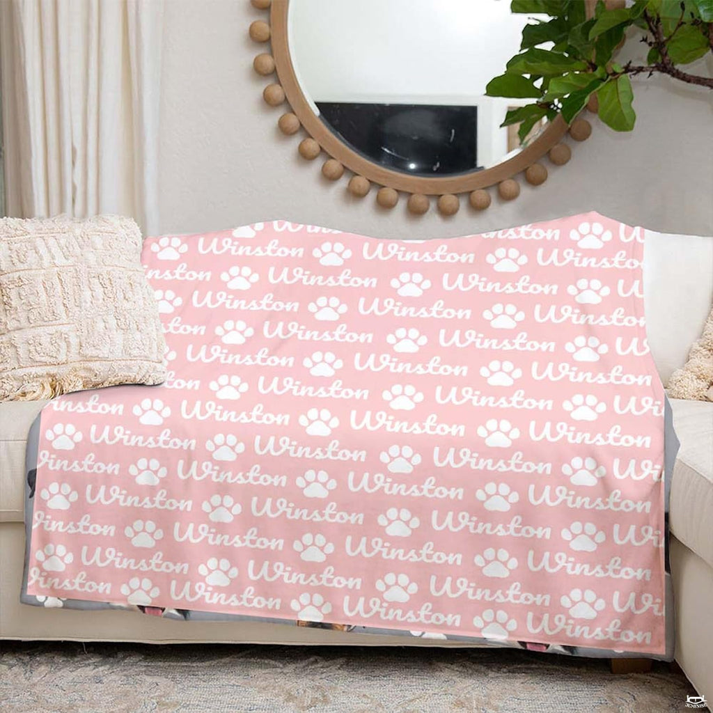 Artistic bedroom display featuring blush pink paw print bedding styled alongside neutral home decor.