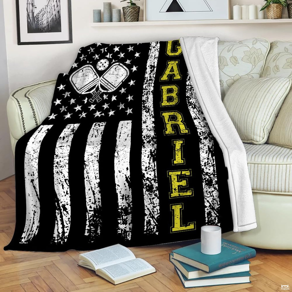 Distressed American flag graphic with crossed pickleball paddles and yellow lettering, view 1.