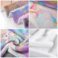 Overhead flat display of pastel rainbow unicorn blanket design